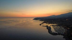 an aerial view of a city on the water at sunset at Il Sole di Sanremo in Sanremo