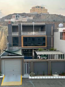 a large building with a parking lot in front of it at شاليه كريكت in Abha