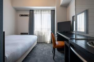 Postel nebo postele na pokoji v ubytování Hotel Vista Ebina