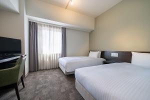 Postel nebo postele na pokoji v ubytování Hotel Vista Ebina