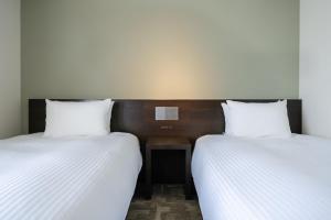 Postel nebo postele na pokoji v ubytování Hotel Vista Ebina