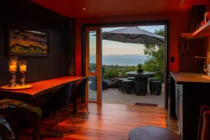 a dining room with a table and an umbrella at The Upside Down in Nelson