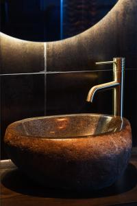 a bathroom sink with a copper faucet at The Upside Down in Nelson