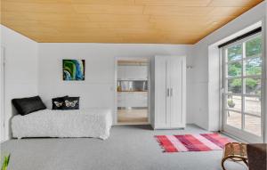 a white room with a bed and a window at Awesome Apartment In Hejls With Kitchen in Hejls
