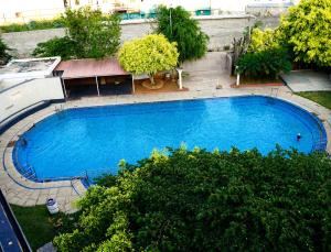 an overhead view of a large blue swimming pool at BNGV Mystic Premier Hotel in Bangalore