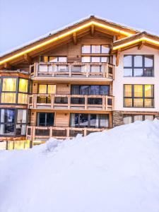 ein großes Gebäude mit Schnee davor in der Unterkunft Panorama Ski Lodge in Zermatt