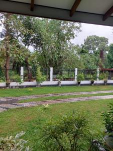 a park with a fence and a grass field at Airport Dulux Green Villa in Minuwangoda +1 photo