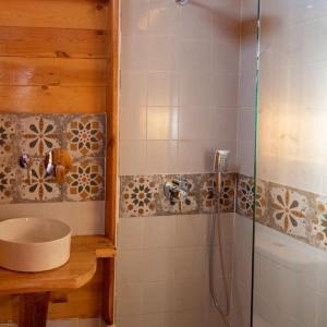 a bathroom with a sink and a shower at Mangrove Camp Fayoum in ‘Ezbet Ilyâs