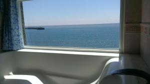 a window in a train looking out at the ocean at Sea Bay in Taitung City