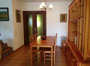 comedor con mesa de madera y sillas en House with pool / Garden / BBQ BEACH, en Tarragona