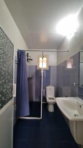 a bathroom with a toilet and a sink and a shower at Family Tides Guest in Kochchikade +18 photos