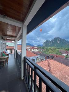 a balcony with a view of a mountain at Jasmine Vangvieng Hotel in Vang Vieng