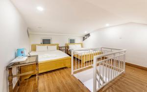 a bedroom with two bunk beds and a staircase at ADALY Hotel Dalat in Xuan An