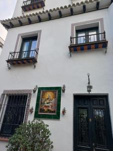 a building with a painting on the side of it at Rest . . . Heliópolis in Seville