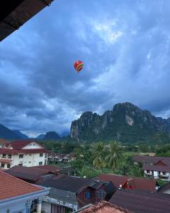 a kite flying in the sky over a city at Jasmine Vangvieng Hotel in Vang Vieng