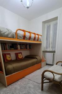 a bedroom with two bunk beds and a chair at Casa Arianna in Avella