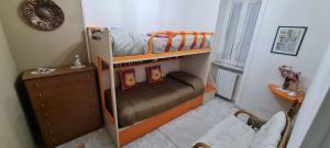 two bunk beds in a small room with a dresser at Casa Arianna in Avella