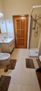 a bathroom with a toilet and a sink and a shower at Casa Arianna in Avella +10 photos