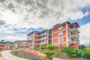 an apartment building on a street under a cloudy sky at Summit Tashi Ghang Heritage Resort in Pelling