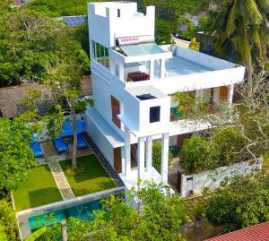 an aerial view of a white house with a pool at The Residence Hikkaduwa in Hikkaduwa