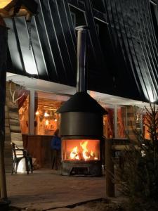 an outdoor oven with a fire inside of it at MONTLO RELAIS DES CERFS in Cubières