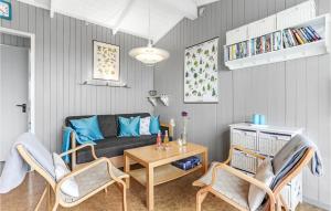 a living room with a couch and a table and chairs at Hus 30 A in Allinge