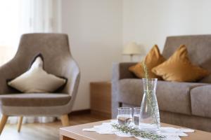 思科納的住宿－沃爾徹霍夫住宅酒店，客厅配有带玻璃杯的桌子和沙发