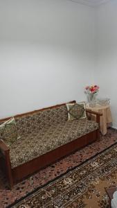 a couch in a living room with a table at Panourgia's House in Tríkala