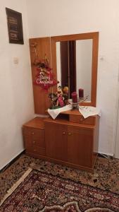a dressing room with a mirror and a dresser at Panourgia's House in Tríkala