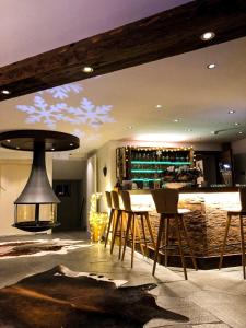 a room with a bar with a table and chairs at Panorama Ski Lodge in Zermatt