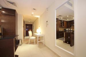 a small kitchen with a table and a mirror at Prime Retreats- Downtown Dubai in Dubai
