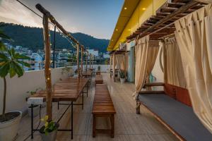 a row of benches on the balcony of a building at Moustache Rishikesh Luxuria in Rishīkesh