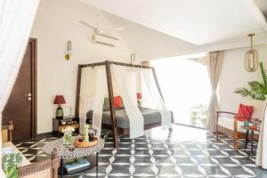 - une chambre dotée d'un lit avec un sol en damier noir et blanc dans l'établissement La Macedo Estate, à Mapusa