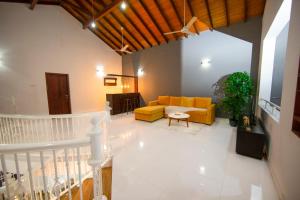 a living room with a yellow couch and a table at The Breeze Residence, Kottawa in Kottawa