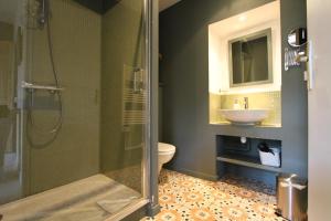 a bathroom with a shower and a toilet and a sink at La Haute Flourie - bed and breakfast -chambres d'hôtes in Saint Malo