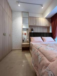 a bedroom with a large bed in a room at Podomoro City Deli Medan Tower Empire - Japandi Style in Medan