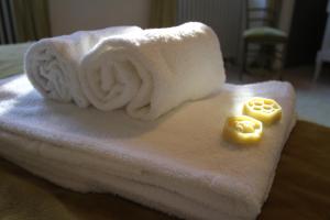 a white towel on a table with two yellow candles at La Haute Flourie - bed and breakfast -chambres d'hôtes in Saint Malo
