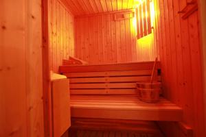 a small wooden sauna with a bucket in it at La Haute Flourie - bed and breakfast -chambres d'hôtes in Saint Malo