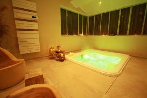 a bathroom with a jacuzzi tub and a sink at La Haute Flourie - bed and breakfast -chambres d'hôtes in Saint Malo +37 photos
