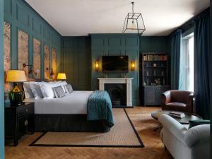 a bedroom with green walls and a bed and a tv at No131 The Promenade in Cheltenham