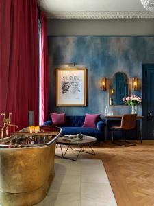 a living room with a blue couch and a table at No131 The Promenade in Cheltenham