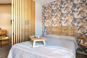 een slaapkamer met een bed met een houten hoofdeinde bij Apto Málaga centro histórico Parking Priv Gratuito in Málaga