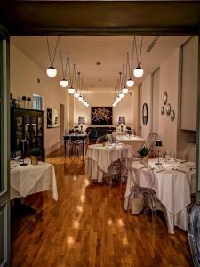 a restaurant with white tables and chairs and lights at RIAMA AGRIRESORT in Naples