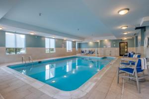 a large pool with blue water in a hotel room at Holiday Inn Express Hotel & Suites Thornburg-S. Fredericksburg by IHG in Thornburg