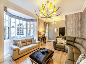 a living room with couches and a chandelier at No3 On The Severn in Bridgnorth