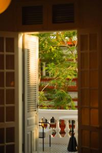 a view of a door with a tree outside of it at 1986 Cafe & Stay in Hai Phong