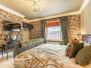 a bedroom with a bed and a chandelier at No3 On The Severn in Bridgnorth