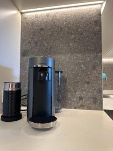 a coffee maker sitting on top of a counter at Mulberry 2BR-2BA Rooftop Pool, BBQ, WiFi & Netflix - Central Location in Canberra