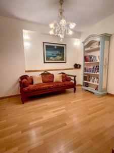 a living room with a couch and a chandelier at Villa Voulgari in Ioannina