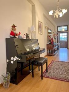 a living room with a piano with stuffed animals on it at Villa Voulgari in Ioannina